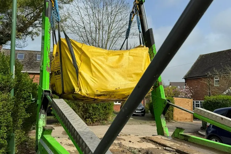 Skip being lifted at a residential job, D J Recycling, West Sussex