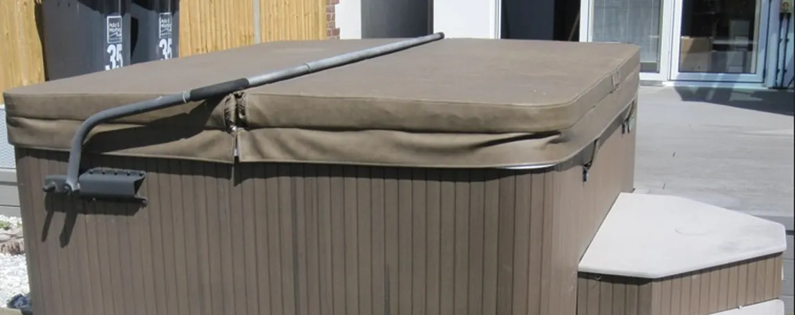 Hard-shell hot tub with cover and steps on a garden patio