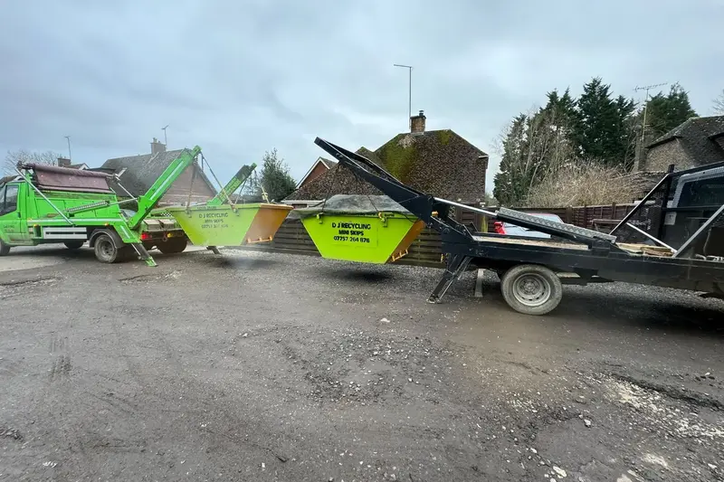 D J Recycling skip lorry lifting two skips